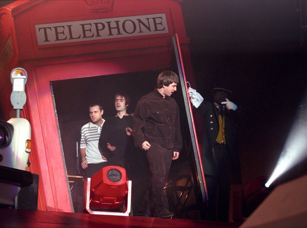 Oasis walk out of London telephone box Wembley 16
