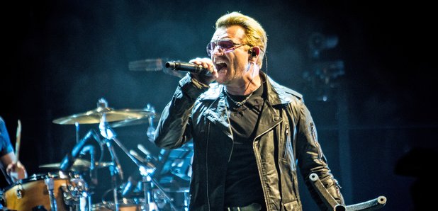 Bono performing in sunglasses