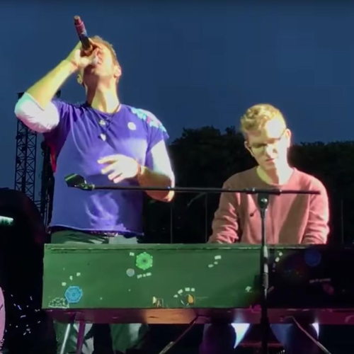 Coldplay's Chris Martin performs with fan